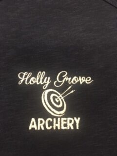 Holly Grove Archery Black garment with white embroidery reading Holly Grove Archery. Target and arrows in center of logo.