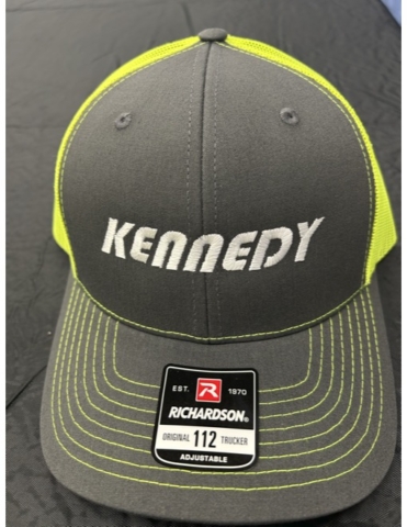 Kennedy Dark gray hat with safety yellow color mesh and thread decorations. Embroidered logo in white reads Kennedy.