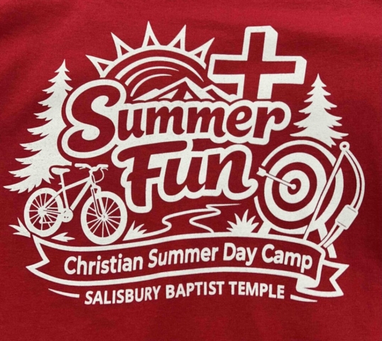 Salisbury Baptist Temple Red shirt with white screen print of text and summer camp imagery, including tree, sun rising, cross, archery and bike. Text reads Summer Fun - Christian Summer Day Camp - Salisbury Baptist Temple.