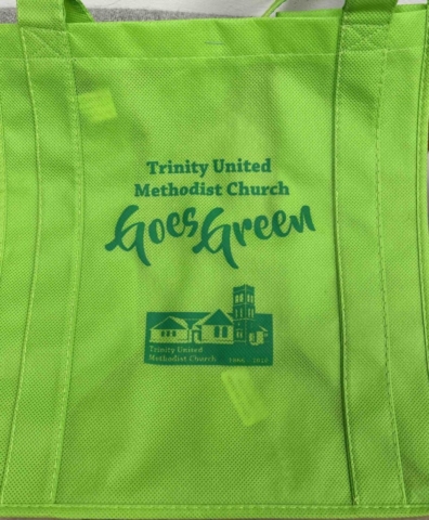 Trinity United Methodist Lime green tote bag with dark green screen print. Image of church and text reads Trinity United Methodist Church goes green.